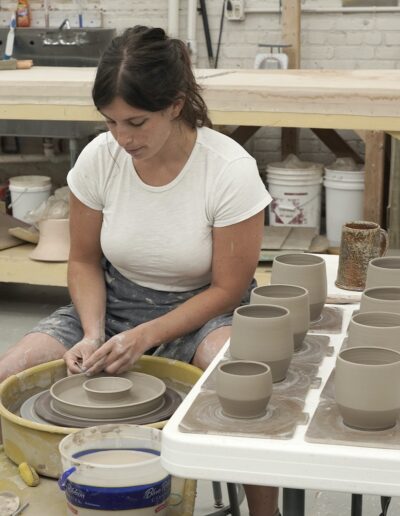 Hannah Barry throwing pots on the potters wheel in ISM studio