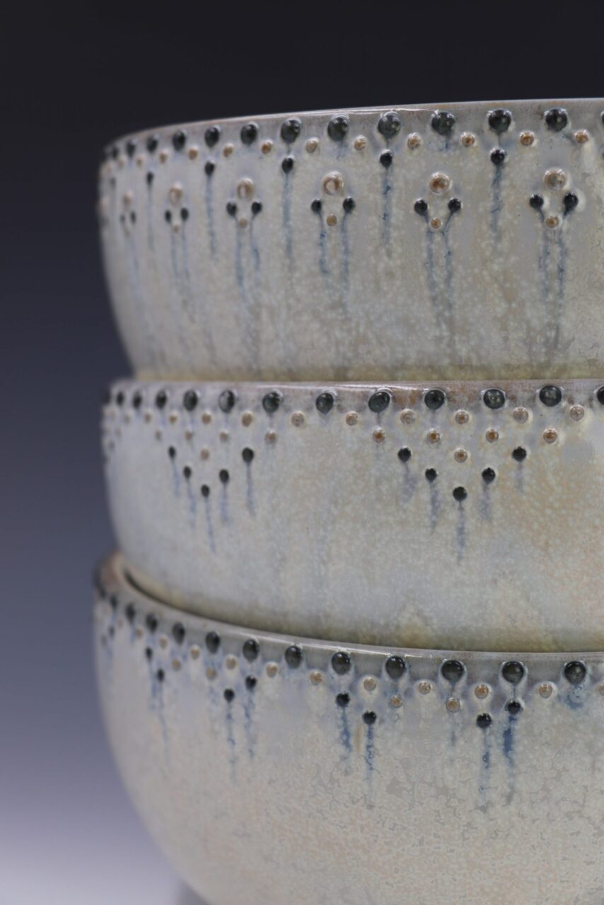 Close up of Katie Meili Messersmith finished pots, dotted serving bowls, dot pots, surface design