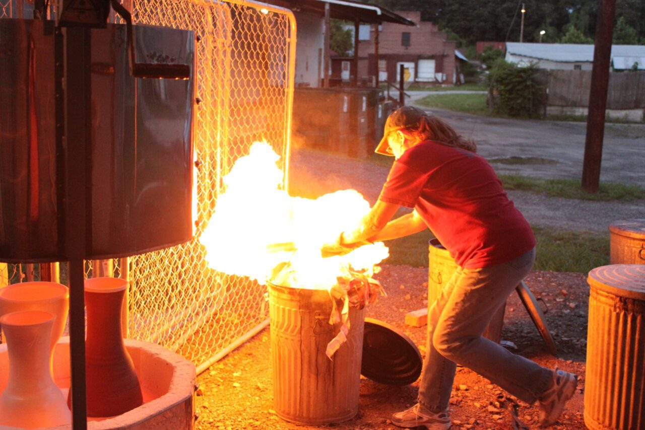 Judi Harwood active raku firing, fire in trash can