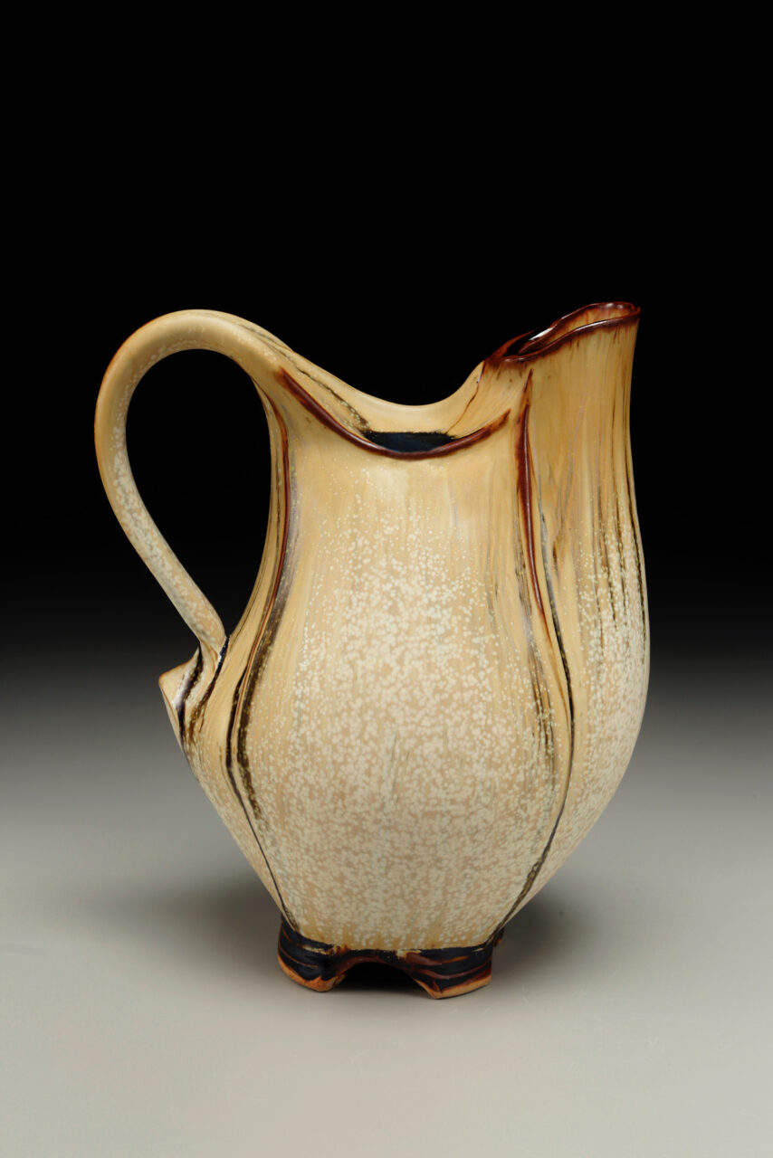 Sarah Wells Rolland Closed Form Pitcher glazed in pumpkin and leach black, finished pot