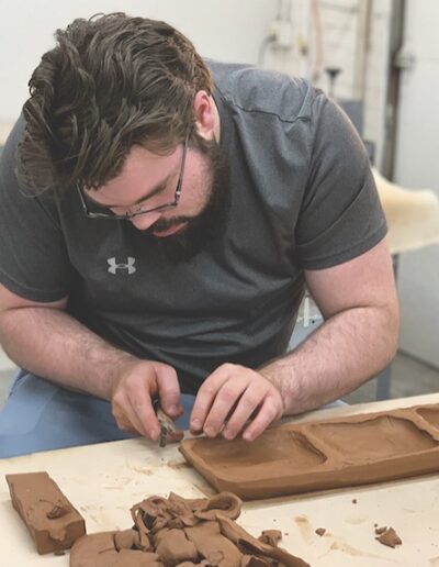 Stephen ISM student carving out tray